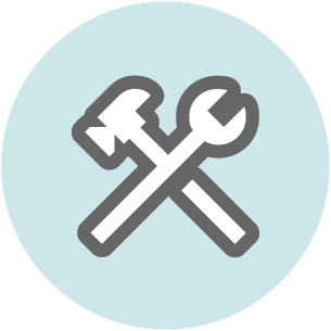 Crossed hammer and wrench tools on a light blue circular background.