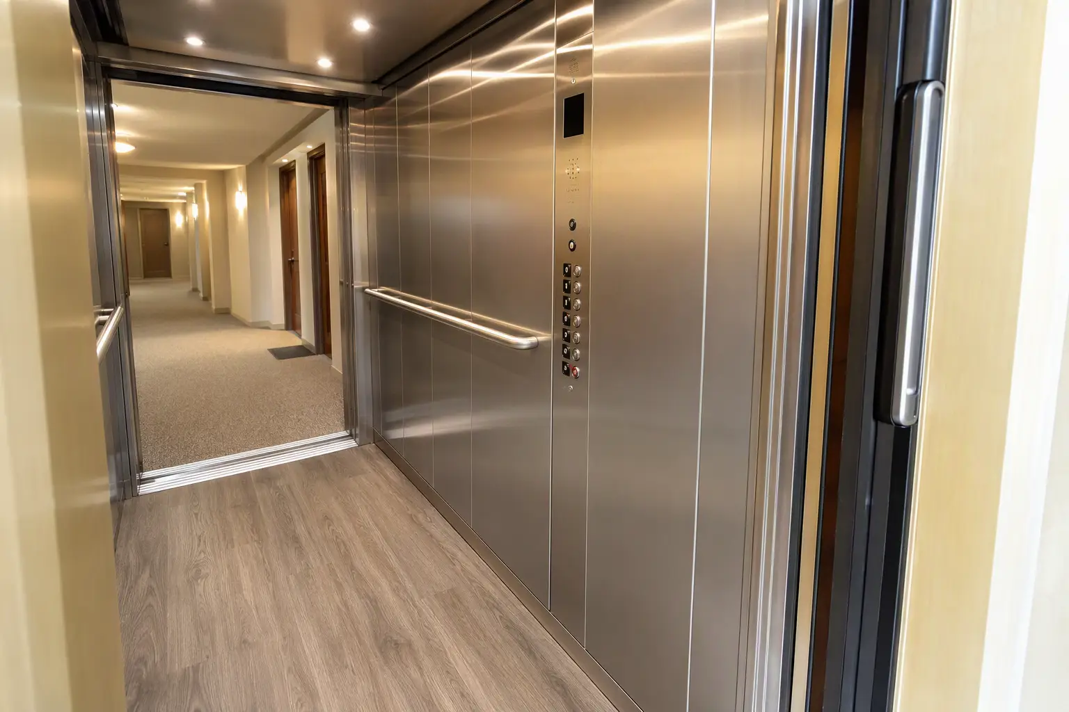 Modernized elevator cab interior with ADA-compliant controls and LED lighting inside a Columbia SC mid-rise apartment building